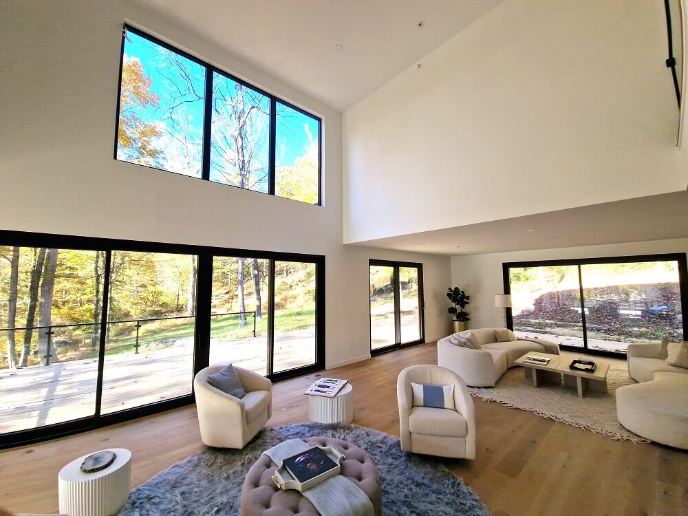 living room with large black aluminium windows Aluprof MB-79N from debesto in luxury villa in woods