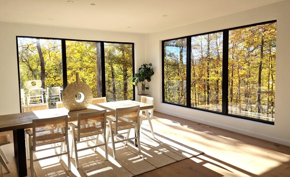 dining room with large black aluminium windows Aluprof MB-79N from debesto in luxury villa in woods