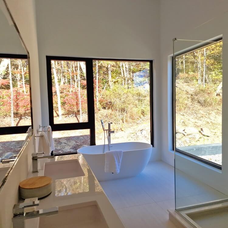 bathroom with large black aluminium windows Aluprof MB-79N from debesto in luxury villa in woods