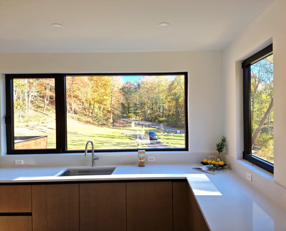 kitchen with large black aluminium windows Aluprof MB-79N from debesto in luxury villa in woods