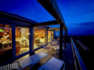 evening patio of long island beach house with white European aluminum windows
