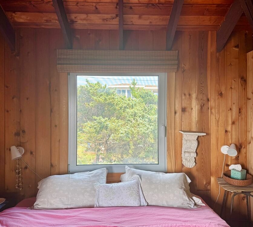 bedroom of long island beach house with white European aluminum tilt turn windows