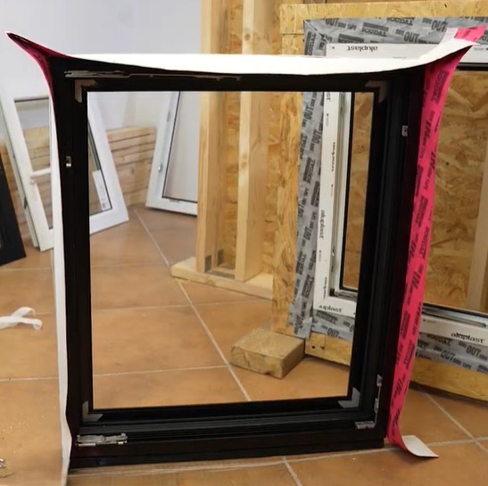 sealing the window frame with a tape