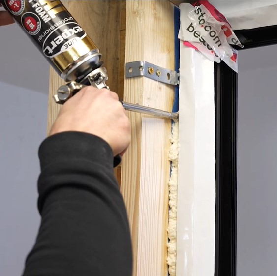 applying the low expansion foam between window fram and the opening